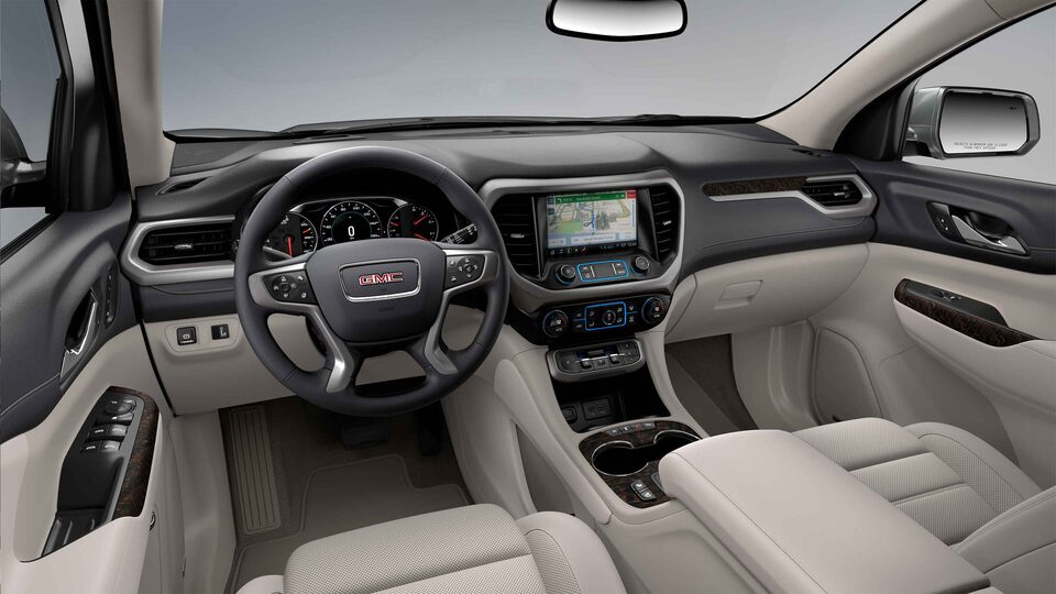Closeup on the Steering Wheel, Heads-Up Display, and Jet Galvanized Light Shale of the new GMC Acadia 