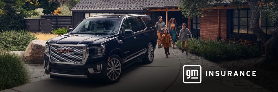 GMC Yukon Large SUV sits in the driveway while a family of four exits the house and is walking toward the vehicle. OnStar Insurance logo is in the bottom right corner of the image