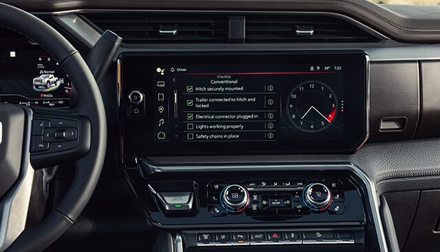GMC Vehicle Interior with the Infotainment Screen Displaying a Trailer Checklist for Conventional Towing