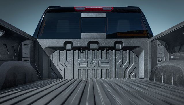 The Interior of a GMC Sierra Pickup Truck Bed With the Embossed GMC Logo on the Bedliner