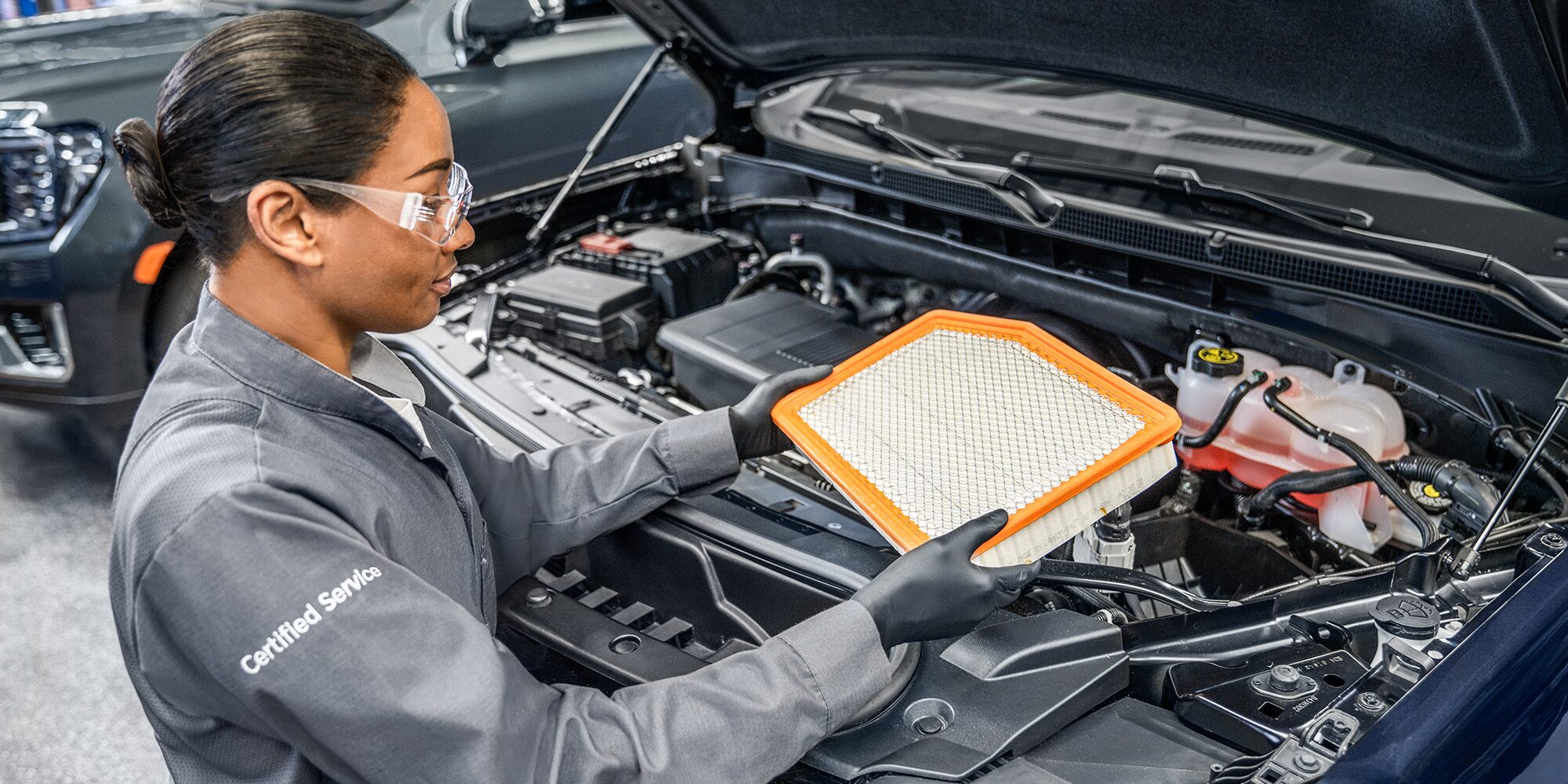 GMC Certified Service Technician Inspecting an Engine Air Filter