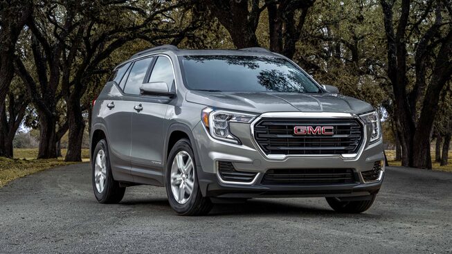 Quicksilver Metallic GMC Terrain SLE Parked On-Road With Trees