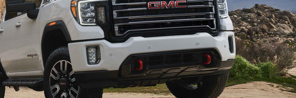 The 2023 Sierra AT4 HD Sleek Front-End Equipped with Vertical Red Recovery Hooks 