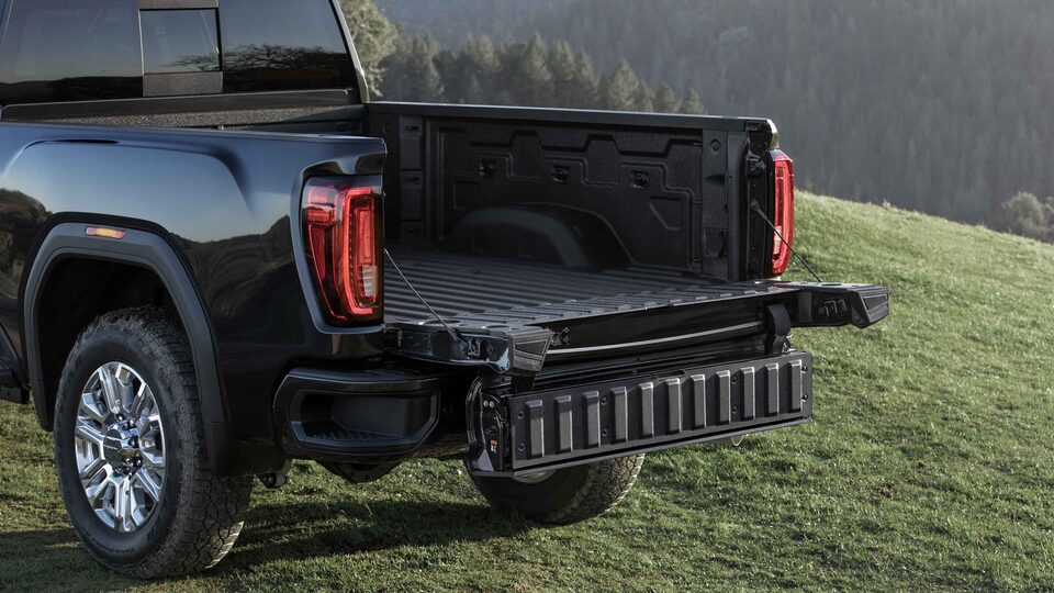 The Multipro Tailgate Inner Gate Fold Feature of the Sierra HD with a Breathtaking Forest Backdrop