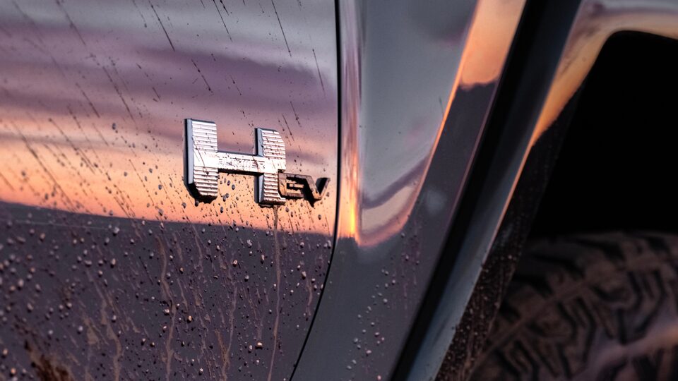 Close-Up View of the 2025 Hummer EV Badging on the Exterior Covered in Mud