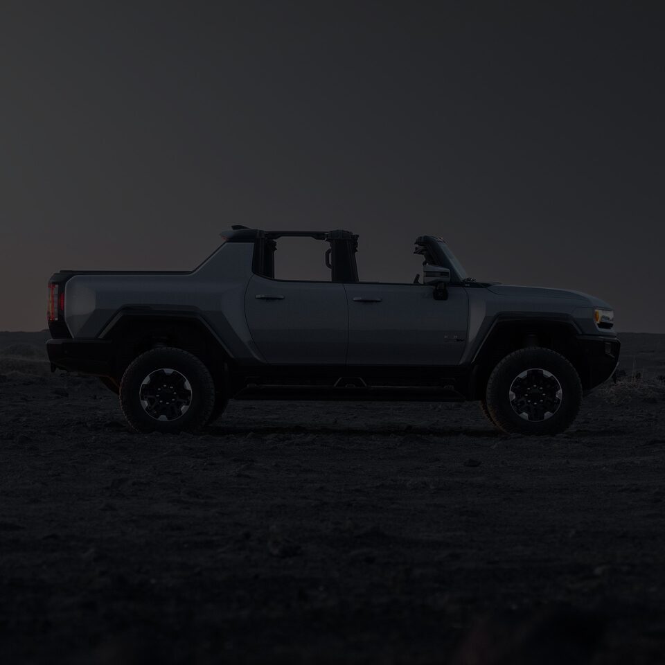 Exterior Side View of the Hummer EV Pickup Truck with a Dark Tint Over the Image and a Text Overlay of "View Exterior"