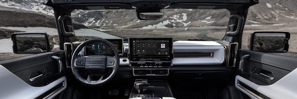 Back Seat View of the 2025 Hummer EV Sleek Dashboard and Advanced Infotainment System Overlooking the Mountains