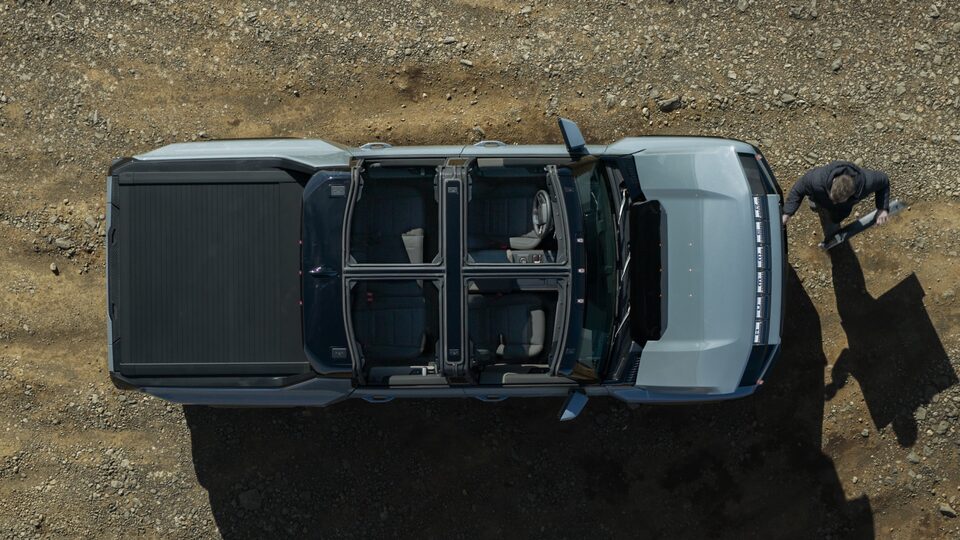 Birdseye View of the Transparent Sky Panels Opened on the 2025 Hummer EV While a Person is About to Load Panel in Front Trunk