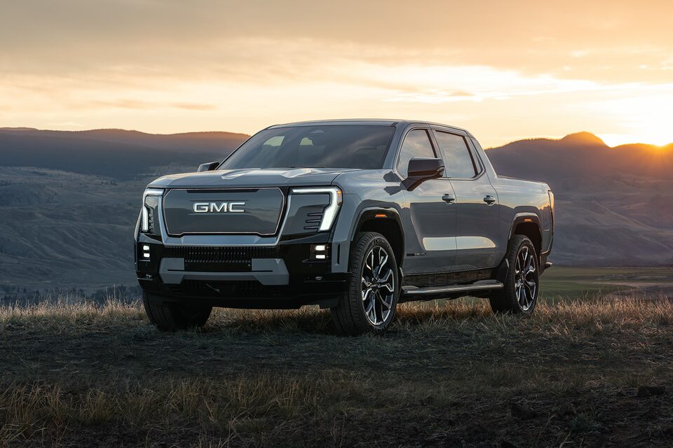Three-Quarters View of a Parked GMC Sierra EV under a Clear Blue Sky