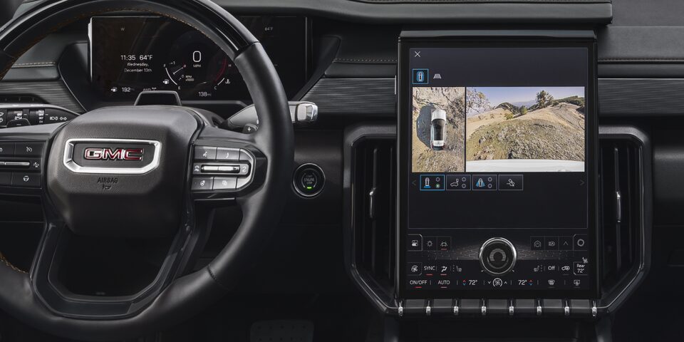 Interior View of the GMC Acadia Steering Wheel, Infotainment System, and Dashboard