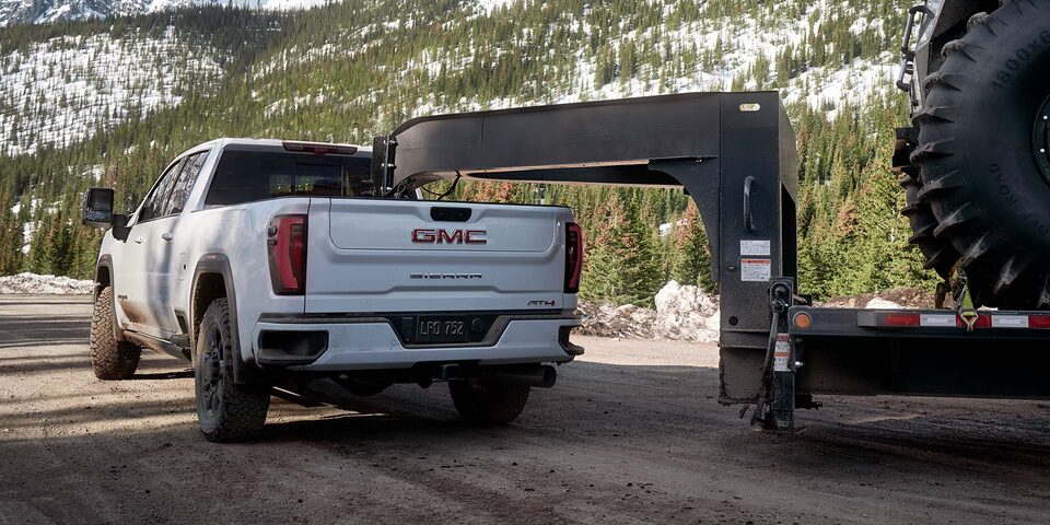 Rear View of a 2025 GMC Sierra HD AT4 Hauling a Large Trailer