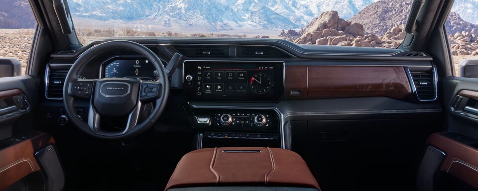 Wide Interior View of the Steering Wheel, Dashboard, and Center Console in a 2025 GMC Sierra HD Truck