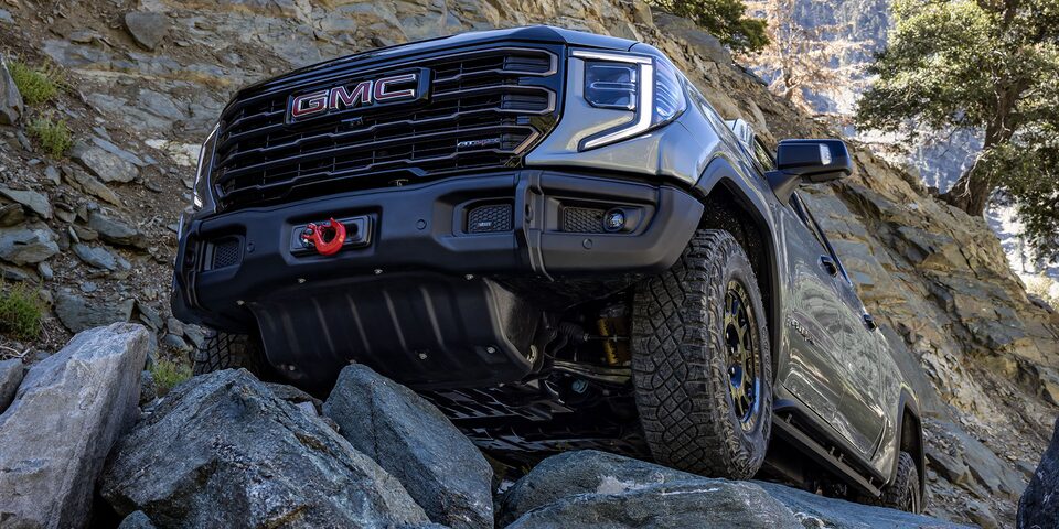 The GMC Sierra AT4 Off-Road Truck Driving Over Rough Terrain