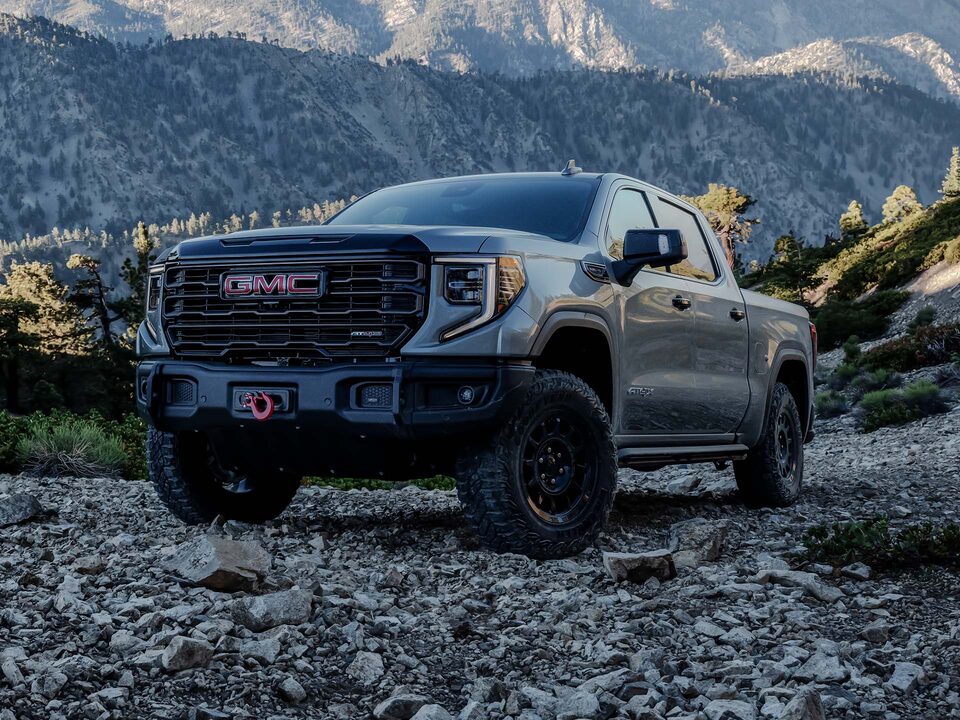 Front Three-Quarter View of the GMC Sierra 1500 AT4 Off-Road Truck Parked on Rocky Terrain