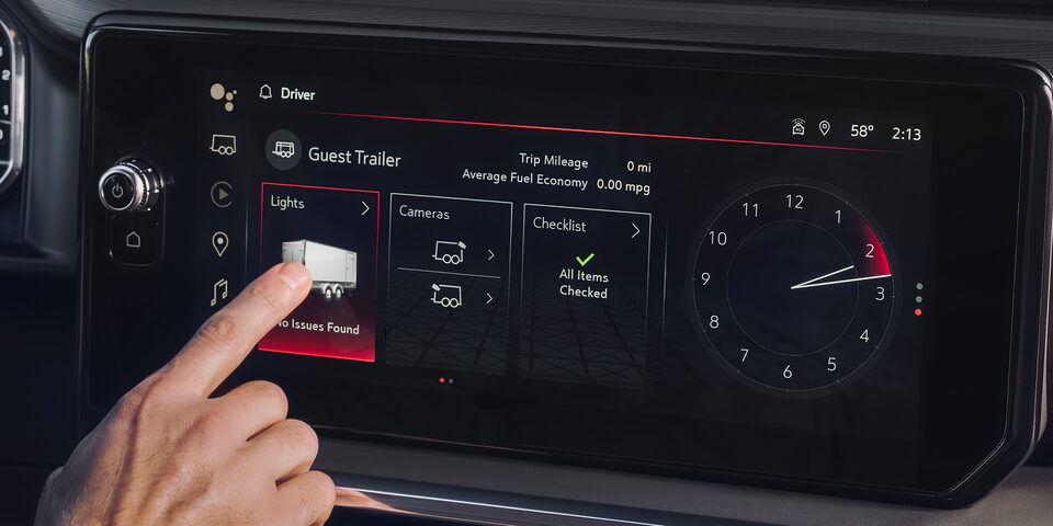 Close-up of a Driver Pressing a Feature Button on the Infotainment System