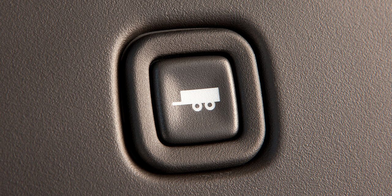 Close-Up of the Towing and Hauling Mode Button in a 2026 GMC Savana Cutaway Van