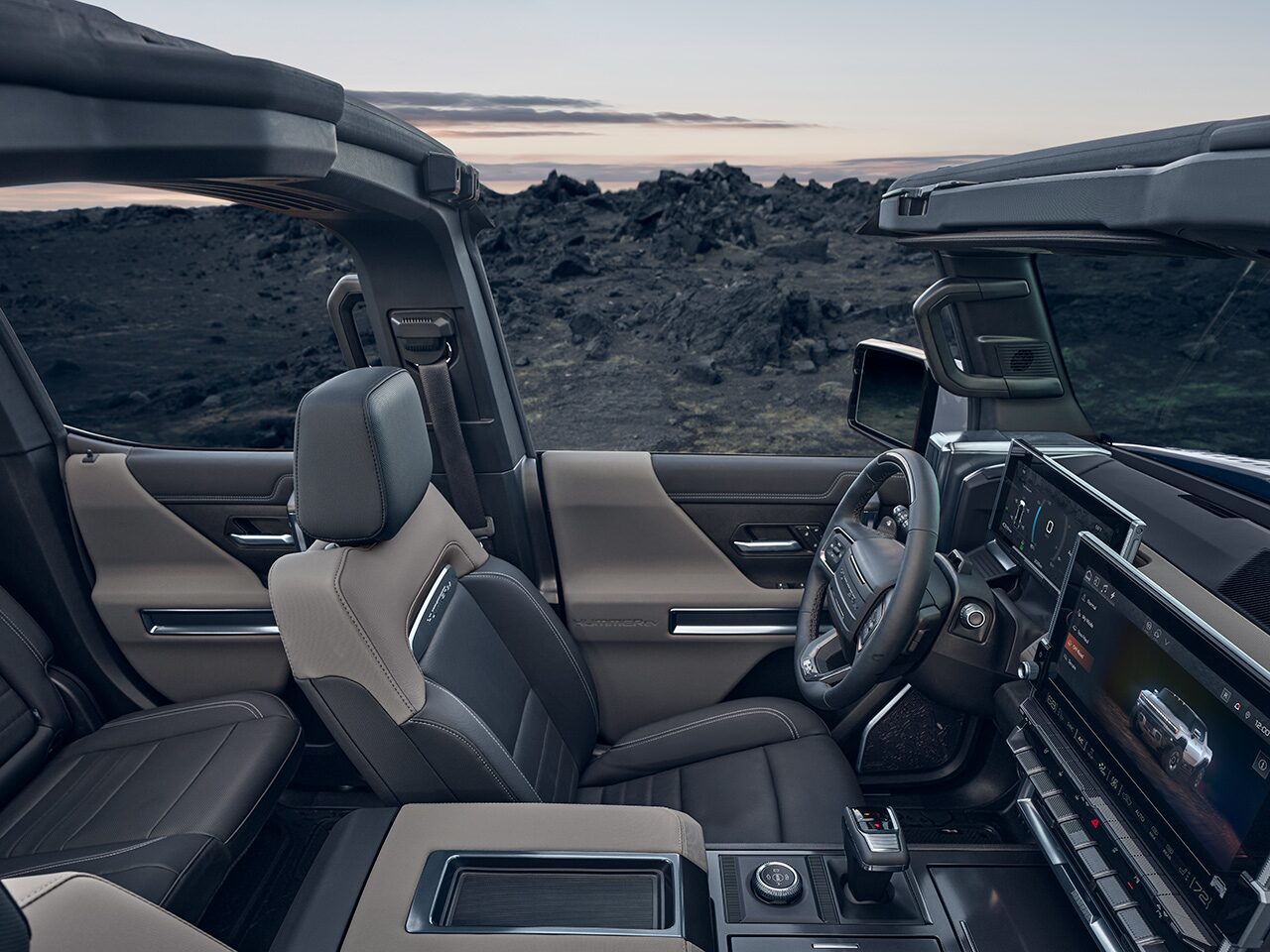 Side View of the 2026 HUMMER EV Front Row and Back Seat Cabin in the Granite Drift Interior Color Theme