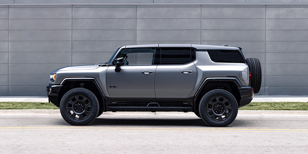 Driver Side View of the 2026 GMC HUMMER EV SUV Parked by a Concrete Wall