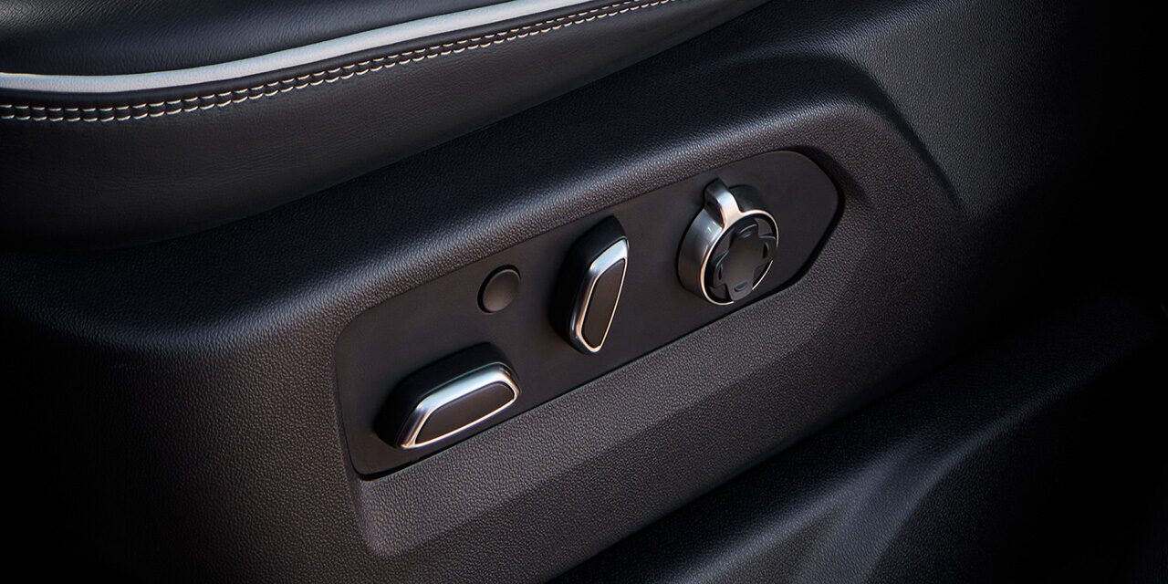 Close-up View of the Seat Controls and "AT4X" Branded Kickplate in a 2026 GMC Sierra HD AT4 Truck