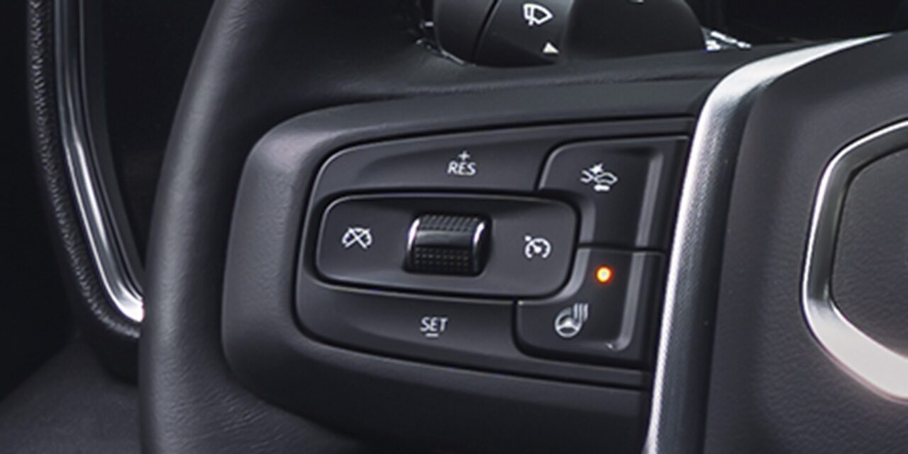 Close-up View of the Adaptive Cruise Control Button on the Steering Wheel